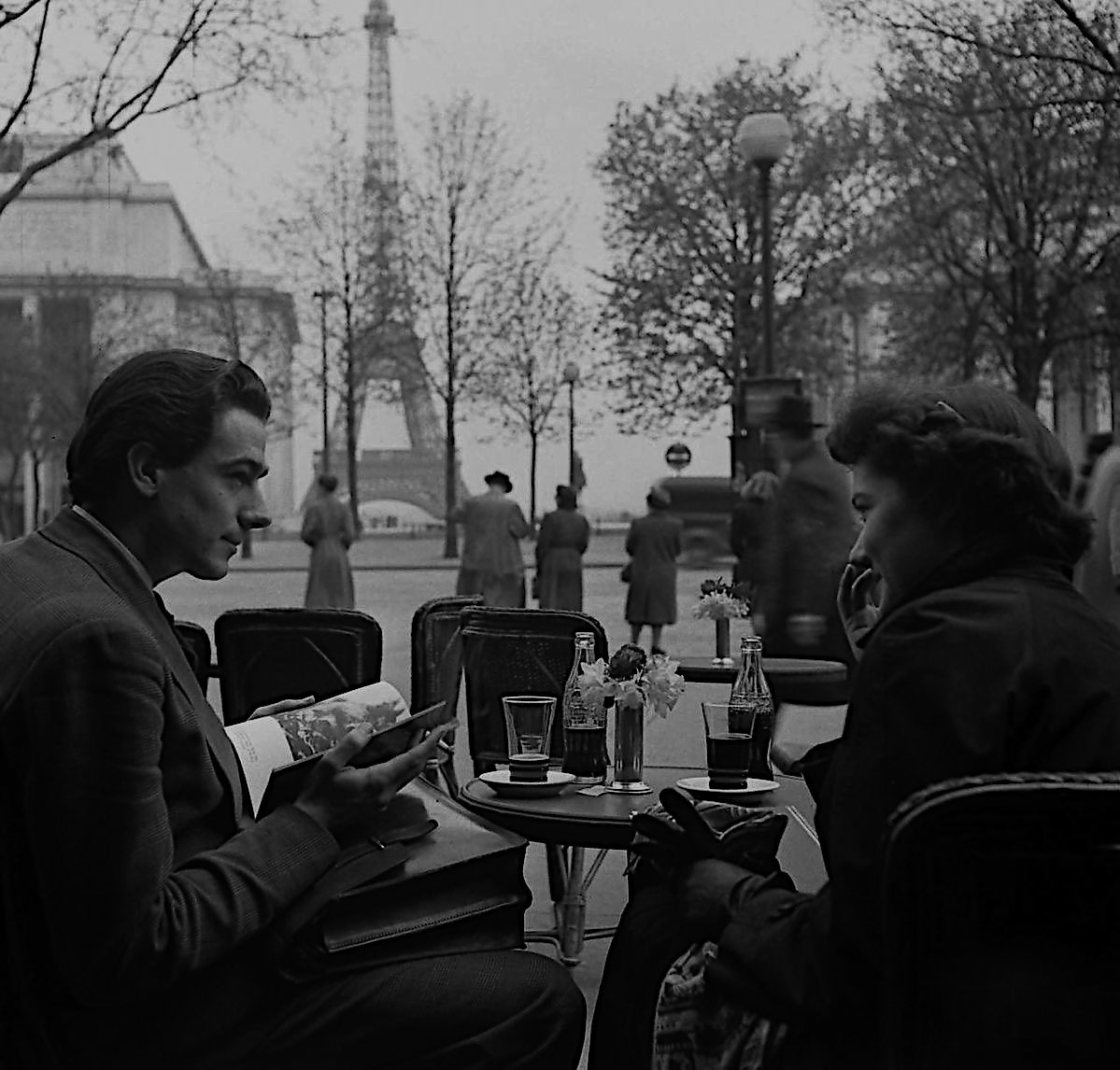 A couple sharing a conversation at a Paris cafe